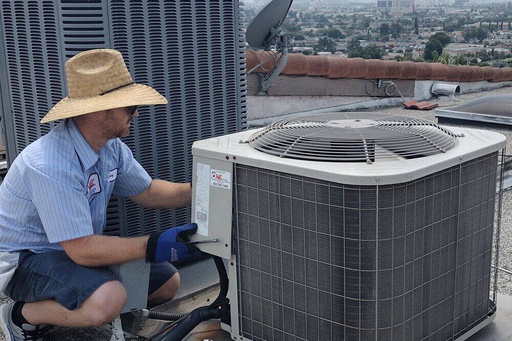 Dial ONE Schilling technician performing rooftop air conditioner service in Long Beach.