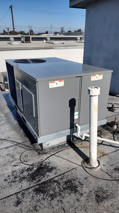 New rooftop packaged HVAC unit installed on flat commercial roof.