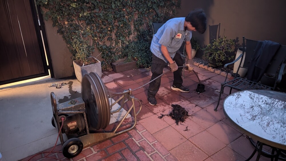 Dial ONE Schilling technician snaking a residential drain.
