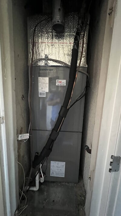 Indoor Innovair HVAC unit installation with insulated refrigerant lines.