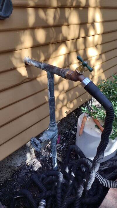Outdoor water spigot repair connected to galvanized and copper piping.