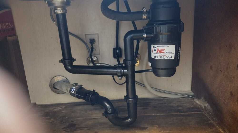 Installed garbage disposal and drain piping under kitchen sink by Dial ONE Schilling Signal Hill, CA—expert plumbing services for local homes.