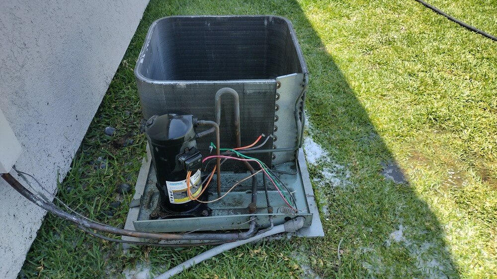 Disassembled air conditioning condenser unit shown during service similar to AC repair jobs completed in Seal Beach.