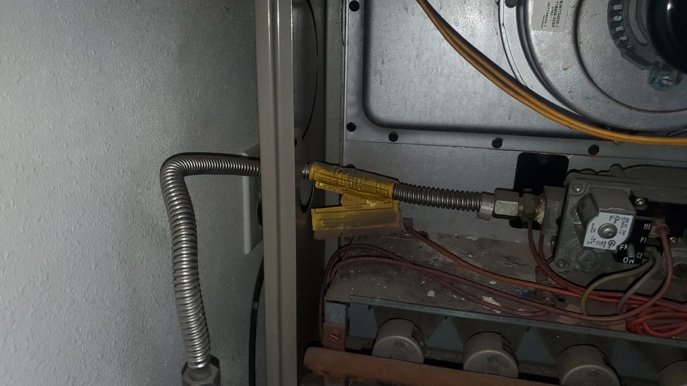 Gas furnace wiring and electrical components during heating system inspection by Dial ONE Schilling.
