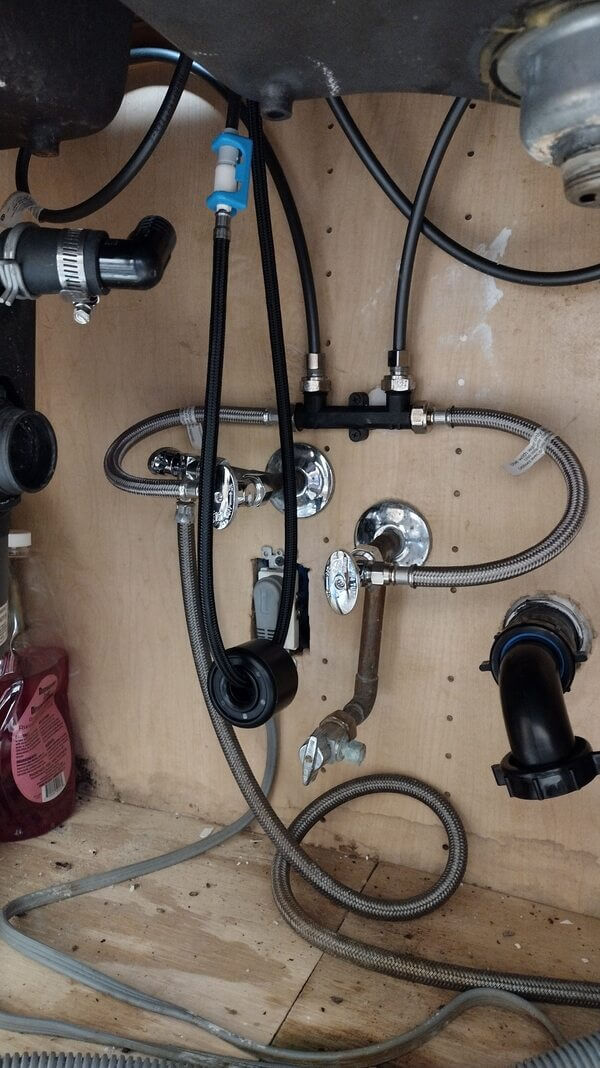Under-sink water supply lines and shut-off valves similar to those serviced by Dial ONE Schilling in Hawaiian Gardens homes.