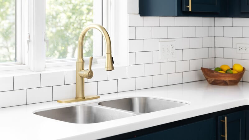 Modern kitchen sink installation with gold faucet in Lakewood, CA