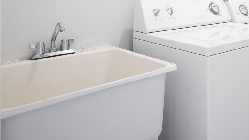Laundry room utility sink installation next to washer in Lakewood, CA