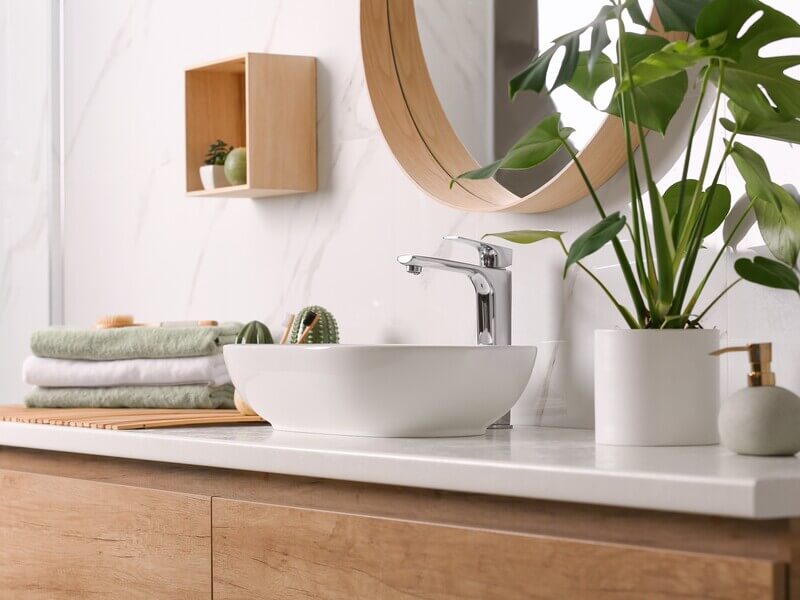 White vessel bathroom sink with chrome faucet on contemporary vanity