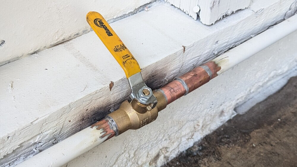 Close-up of copper water supply line with ball valve after professional repair in Lakewood, CA